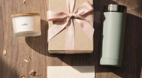 Curated selection of affordable best friend gifts including a candle, tumbler, and wrapped box under 50 dollars