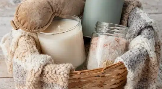 A curated self-care gift basket with relaxation items on a rustic wooden table